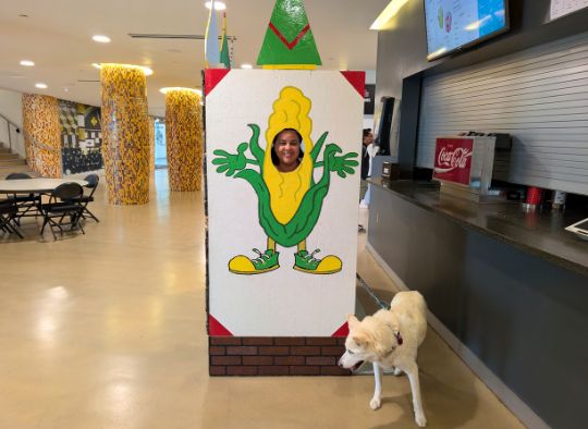 Person and dog in corn photo op inside lobby of Corn Palace