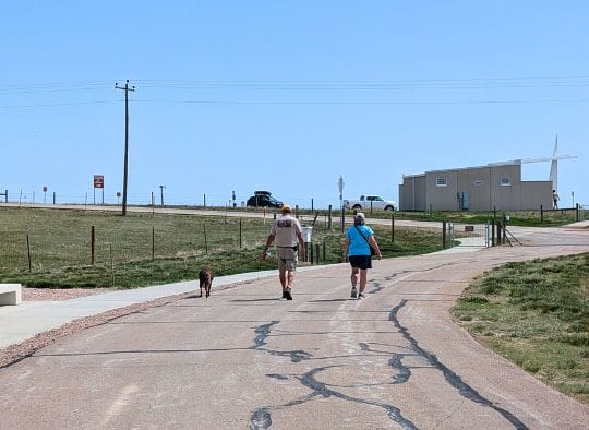 A couple and their dog walking back to the Parking area at Delta 01